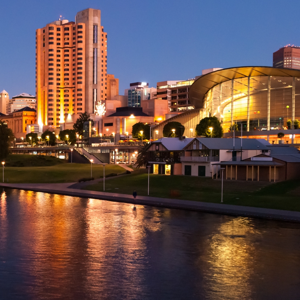 Photo of the Convention Centre and SkyCity casino behind the River Torrens at night.